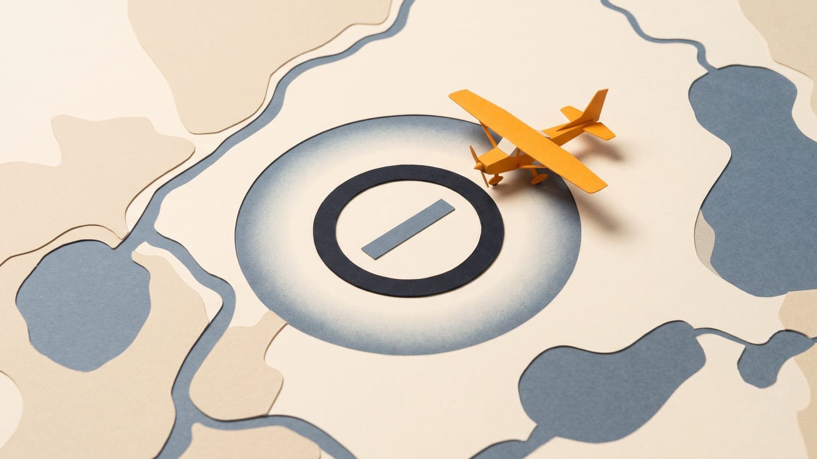 Cut-paper collage of a small orange high-wing airplane on a map of lakes and land beside a dark ring with a soft shaded halo, the way a chart marks Class E airspace.
